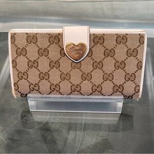 Gucci GG Canvas Long Wallet featuring white leather and heart-shaped closure